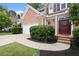 Charming brick home showcasing a well-manicured lawn and a covered front entrance at 1010 Graystone Xing, Alpharetta, GA 30005