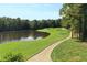 Picturesque golf course view by a tranquil lake, surrounded by mature trees and lush green landscapes at 1010 Graystone Xing, Alpharetta, GA 30005