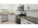 Updated kitchen with stainless steel appliances and granite countertops at 1010 Graystone Xing, Alpharetta, GA 30005