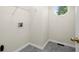Spacious laundry room with tile flooring, overhead shelving, and an octagon window at 1010 Graystone Xing, Alpharetta, GA 30005