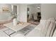 Comfortable living room with a soft couch, stylish coffee table, and open view to dining area at 1010 Graystone Xing, Alpharetta, GA 30005
