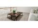 Relaxing living room area with a sofa, coffee table, and view of the staircase at 1010 Graystone Xing, Alpharetta, GA 30005