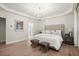 Inviting main bedroom showcases plush bed, modern lighting, and ensuite bathroom access at 1010 Graystone Xing, Alpharetta, GA 30005