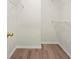 Empty walk-in closet with wooden floors and white wire shelves for storage at 1010 Graystone Xing, Alpharetta, GA 30005