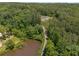 Expansive aerial view of a home with a pond and lush greenery at 212 Postell Rd, Dallas, GA 30157