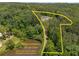 Aerial shot of home within lot and trees, with a pond nearby and private drive at 212 Postell Rd, Dallas, GA 30157