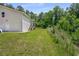 Spacious backyard featuring a well-maintained lawn, surrounded by lush trees and natural landscaping at 212 Postell Rd, Dallas, GA 30157