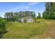 Spacious backyard featuring a well-maintained lawn and mature trees, perfect for outdoor activities at 212 Postell Rd, Dallas, GA 30157