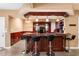 Basement bar with seating, dark wood accents, pendant lighting, and built-in shelving, perfect for entertaining at 212 Postell Rd, Dallas, GA 30157