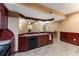 Basement bar area with ample cabinetry, a modern sink, and a functional layout, perfect for entertaining guests at 212 Postell Rd, Dallas, GA 30157