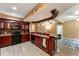 Basement kitchen bar area with dark wood cabinets, modern appliances, sink and seating, perfect for hosting guests at 212 Postell Rd, Dallas, GA 30157