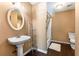 Bathroom with a pedestal sink, stylish shelves, and shower-tub combination at 212 Postell Rd, Dallas, GA 30157