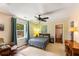 Cozy bedroom with natural light, featuring a comfortable bed, desk, chair, and serene decor, perfect for relaxation at 212 Postell Rd, Dallas, GA 30157
