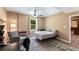 Cozy bedroom with neutral colors, ceiling fan, and natural light from the window at 212 Postell Rd, Dallas, GA 30157