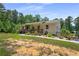 Inviting single-story home with a covered porch, complemented by colorful flowers and greenery at 212 Postell Rd, Dallas, GA 30157