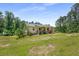 Charming single-story home with a well-manicured lawn, surrounded by lush trees on a sunny day at 212 Postell Rd, Dallas, GA 30157