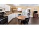 Eat-in kitchen with white cabinets, stainless steel appliances, and laminate floors at 212 Postell Rd, Dallas, GA 30157