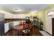 Full shot of kitchen area with white cabinets, stainless appliances, wood floors and dining table at 212 Postell Rd, Dallas, GA 30157