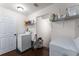 Practical laundry room with a washer, dryer, and storage shelves for supplies at 212 Postell Rd, Dallas, GA 30157