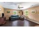 Comfortable living room featuring hardwood floors, a ceiling fan, and natural light from two windows at 212 Postell Rd, Dallas, GA 30157
