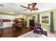 Inviting living space with wood floors, white cabinetry, dining table, and comfortable sitting area, creating a warm atmosphere at 212 Postell Rd, Dallas, GA 30157