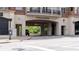 The Aramore building entrance is an urban design with brick and concrete finishes and balcony detail above at 2277 Peachtree Ne Rd # 611, Atlanta, GA 30309