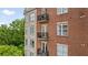 Multi-story brick building featuring individual unit balconies, blending residential charm with urban living at 2277 Peachtree Ne Rd # 611, Atlanta, GA 30309