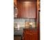 Close-up of kitchen featuring granite countertops, a tile backsplash, and wood cabinetry at 2277 Peachtree Ne Rd # 611, Atlanta, GA 30309