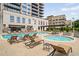 Resort-style pool and hot tub, surrounded by comfortable lounge chairs and lush landscaping at 2277 Peachtree Ne Rd # 611, Atlanta, GA 30309
