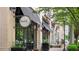 Sidewalk view of Starfish restaurant exterior with a black awning, lush greenery, and ambient lighting at 2277 Peachtree Ne Rd # 611, Atlanta, GA 30309