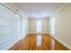 A spacious bedroom with hardwood floors, neutral walls, and built-in closet space at 3091 Colonial Way # I2, Atlanta, GA 30341