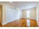 Bedroom featuring warm toned walls, wood floor, and large sliding closet at 3091 Colonial Way # I2, Atlanta, GA 30341