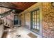 Apartment entrance featuring brick walls, an exterior staircase, and dark green doors with large windows at 3091 Colonial Way # I2, Atlanta, GA 30341