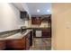 Kitchenette with granite countertops, dark wood cabinets, tile floors, and stainless steel appliances at 3091 Colonial Way # I2, Atlanta, GA 30341