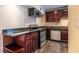 Cozy kitchenette featuring stainless steel appliances, granite countertops, and dark wood cabinetry at 3091 Colonial Way # I2, Atlanta, GA 30341