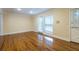 Living room showcasing hardwood floors, neutral paint, double windows, and a door leading to outdoor space at 3091 Colonial Way # I2, Atlanta, GA 30341