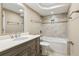 Bathroom with a vanity, a toilet, and a tub with tile surround and silver fixtures at 4217 Wieuca Overlook Ne, Atlanta, GA 30342