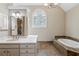 Elegant bathroom featuring a soaking tub, tile accents, and a large vanity with modern fixtures at 4217 Wieuca Overlook Ne, Atlanta, GA 30342