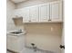 Laundry room with white cabinets, sink, and tiled floor providing function and style at 4217 Wieuca Overlook Ne, Atlanta, GA 30342