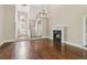 Grand living room boasts hardwood floors, fireplace, chandelier, and staircase at 4217 Wieuca Overlook Ne, Atlanta, GA 30342
