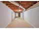 Unfinished basement area offering ample space with visible ductwork on the ceiling at 616 Lone Oak Ct, Lithonia, GA 30058