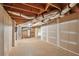 Unfinished basement area featuring exposed ductwork, concrete floor, and a water heater at 616 Lone Oak Ct, Lithonia, GA 30058