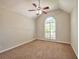 Bedroom with arched window, vaulted ceilings, plush carpeting, and neutral walls providing a serene retreat at 616 Lone Oak Ct, Lithonia, GA 30058