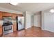 Kitchen featuring stainless steel appliances, wooden cabinetry, and a breakfast nook area with wood-look floors at 616 Lone Oak Ct, Lithonia, GA 30058