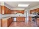 Kitchen featuring stainless steel appliances, granite countertops, wooden cabinetry, and a view to the sun-filled back yard at 616 Lone Oak Ct, Lithonia, GA 30058
