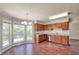 Kitchen with wood cabinetry, granite countertops, stainless steel appliances and an adjacent breakfast nook filled with light at 616 Lone Oak Ct, Lithonia, GA 30058
