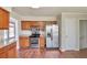 Kitchen with stainless steel appliances, granite countertops, and wooden cabinets adjacent to an entryway at 616 Lone Oak Ct, Lithonia, GA 30058