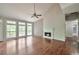 Bright living room with a fireplace, vaulted ceilings, and large windows offering natural light and scenic views at 616 Lone Oak Ct, Lithonia, GA 30058