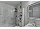 Updated bathroom with a glass-enclosed shower, and built-in storage at 1358 Millstream Trl, Lawrenceville, GA 30044