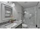 Modern bathroom with granite countertops, glass-enclosed shower, and a mirror at 1358 Millstream Trl, Lawrenceville, GA 30044